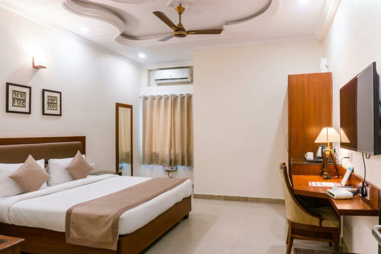 Comfortable hotel room featuring modern interior design with wooden furniture and soft lighting.
